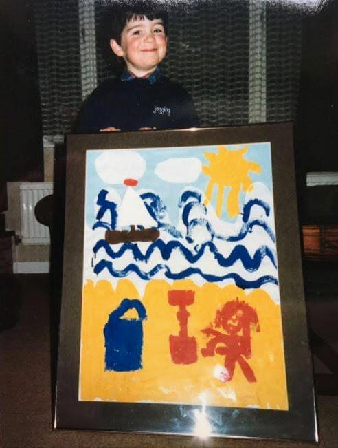 The artist as a young man Photograph of me around 4-5 years old proudly holding up my big seaside painting, framed.